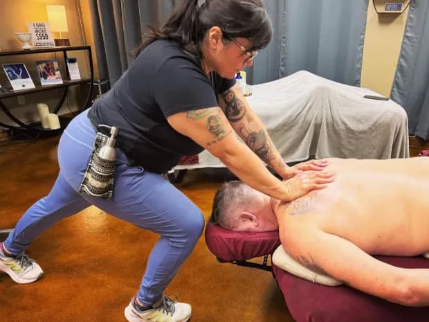 Diana working along a client's back